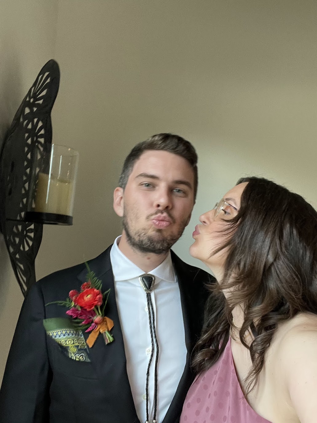 Jason and Ashley doing kissy faces at a friend's wedding